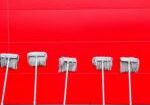 Row of mops on red background